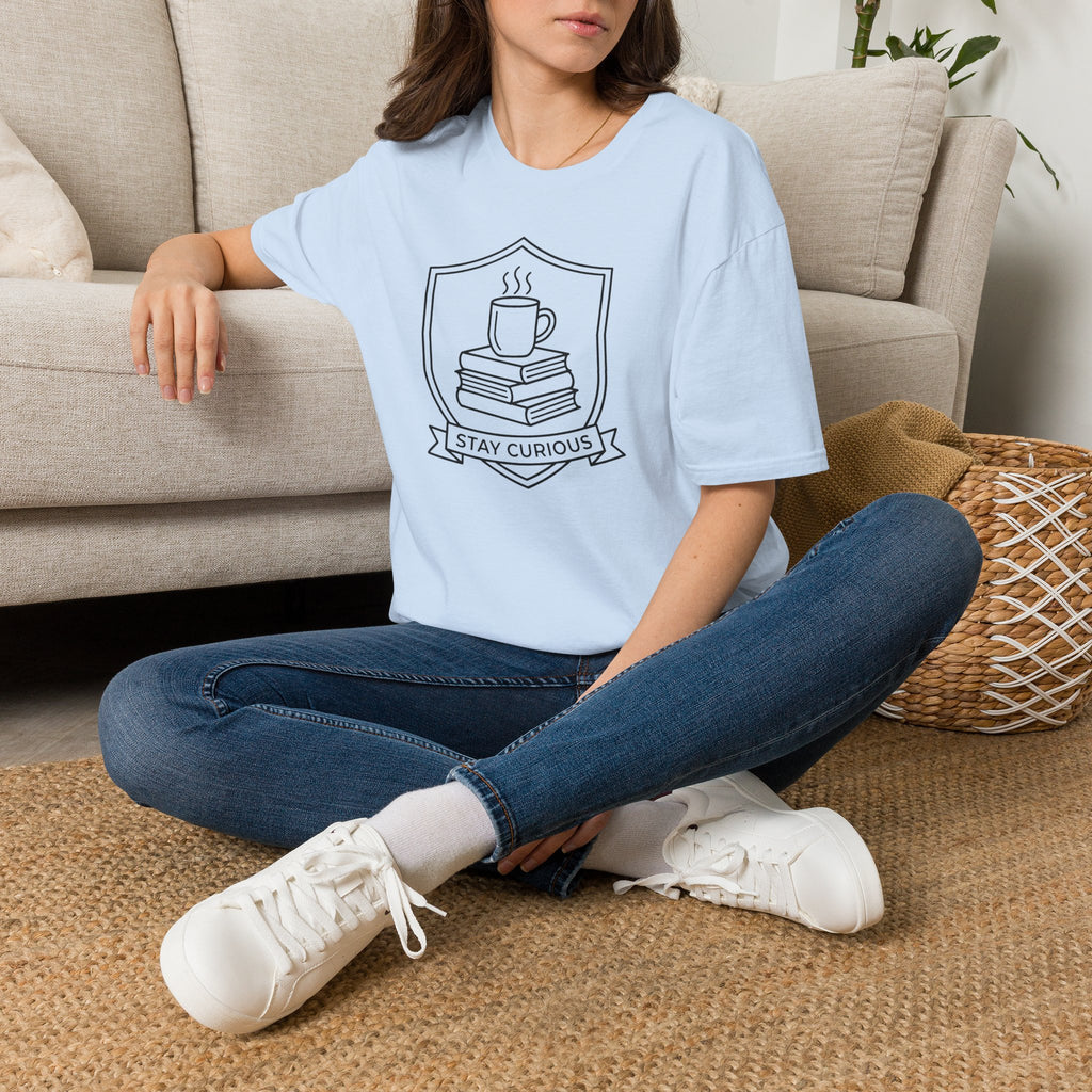 Light blue t-shirt with cup-and-books crest graphic, crew neck.