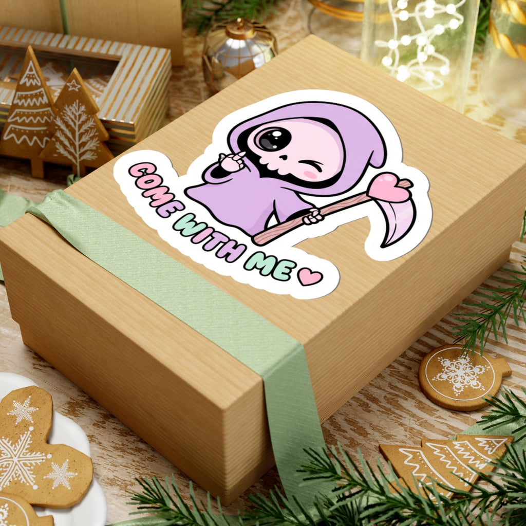 Purple grim reaper sticker on a wrapped gift, scythe and heart, “COME WITH ME”.