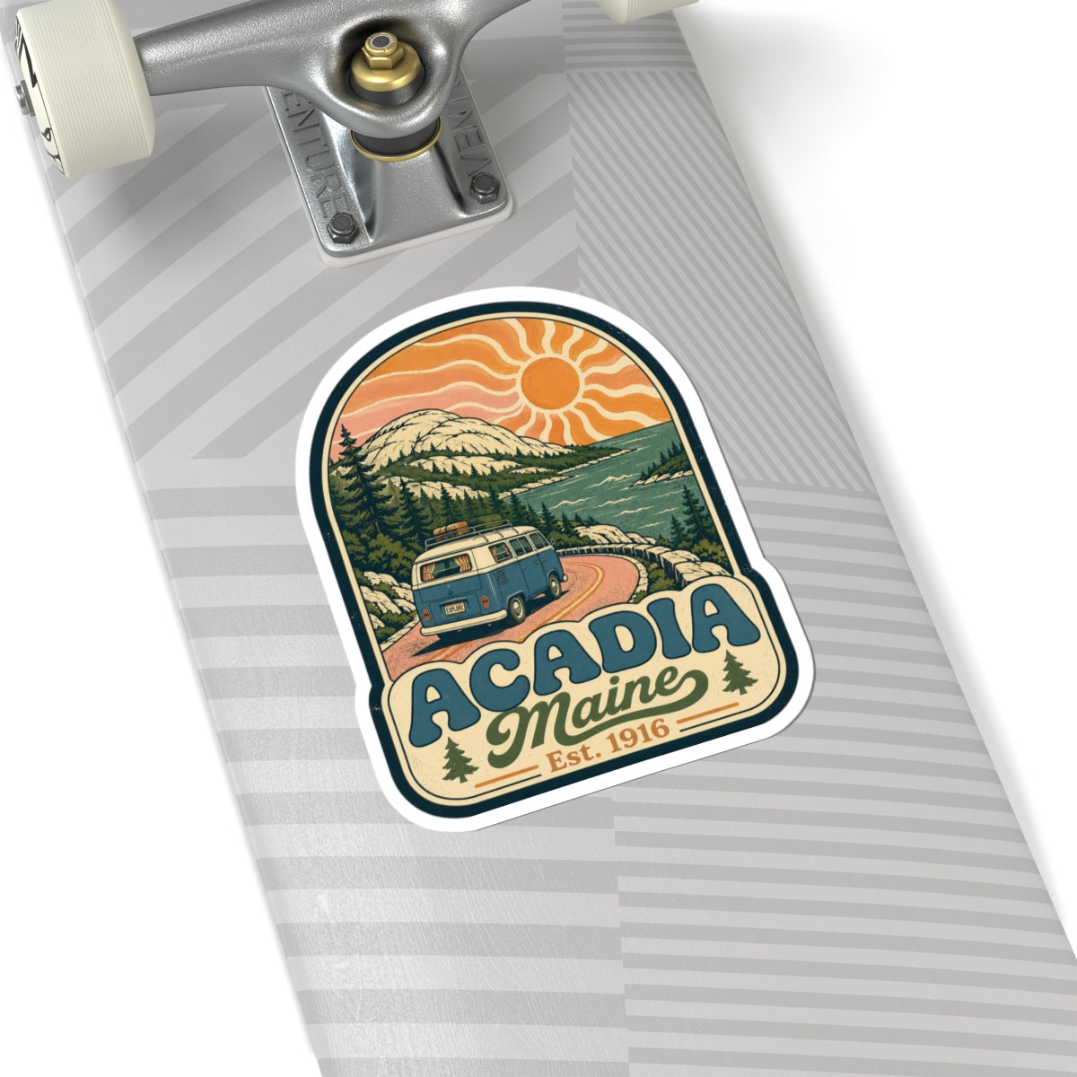Acadia Maine sticker on skateboard deck, retro camper van landscape, orange sun, Est. 1916