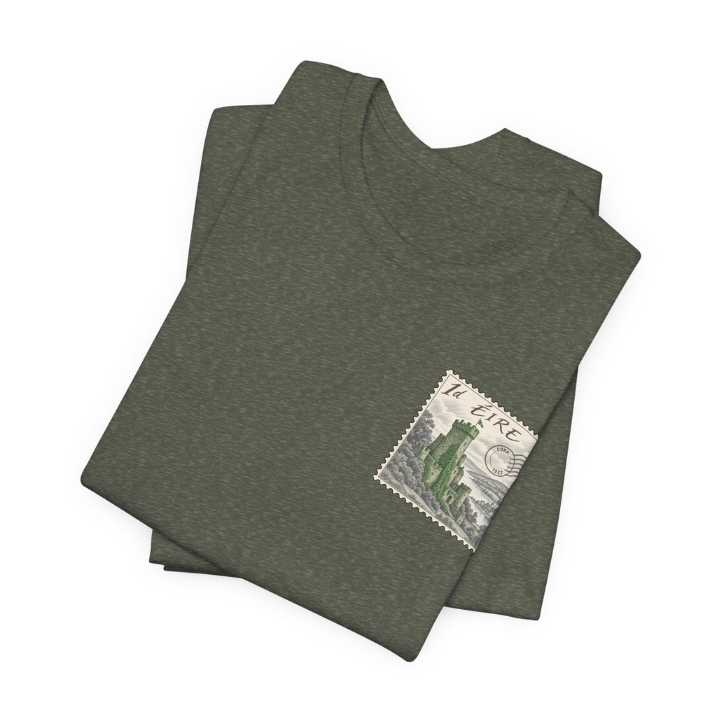 Dark heather T-shirt, folded view with small vintage postage stamp graphic on chest.
