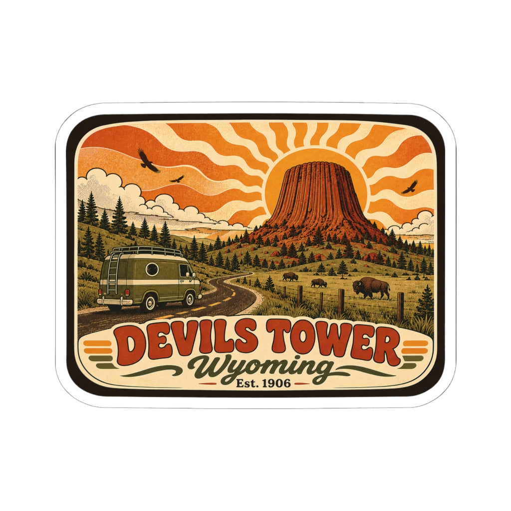 Die-cut Devils Tower Wyoming sticker, retro pine forest scene with bus and bold title.