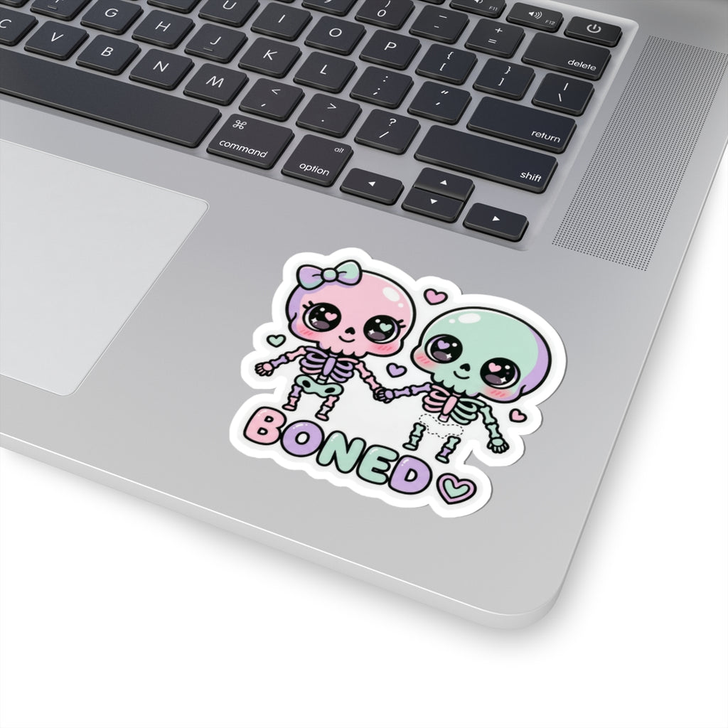 Pastel skeleton couple sticker with 'BONED' lettering and small heart accents