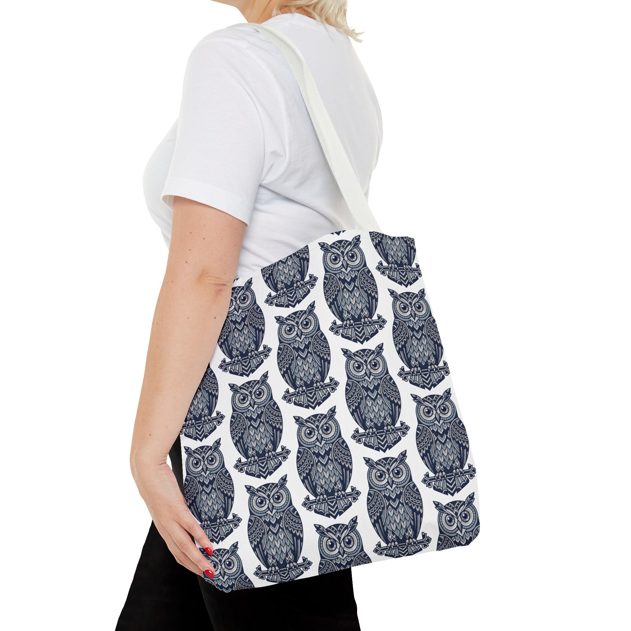 Tote bag with navy owl pattern and white handles, side profile view