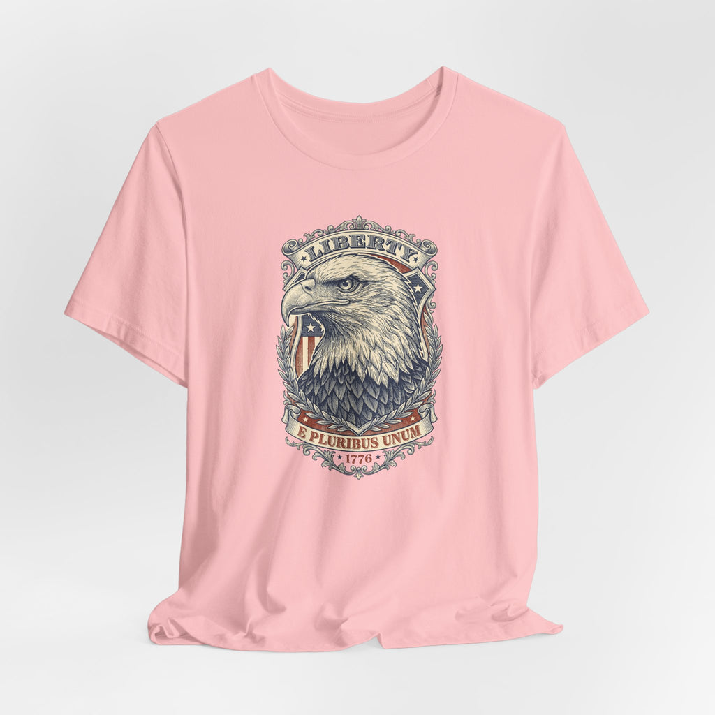 Pink T-shirt with centered liberty eagle head graphic in an oval badge