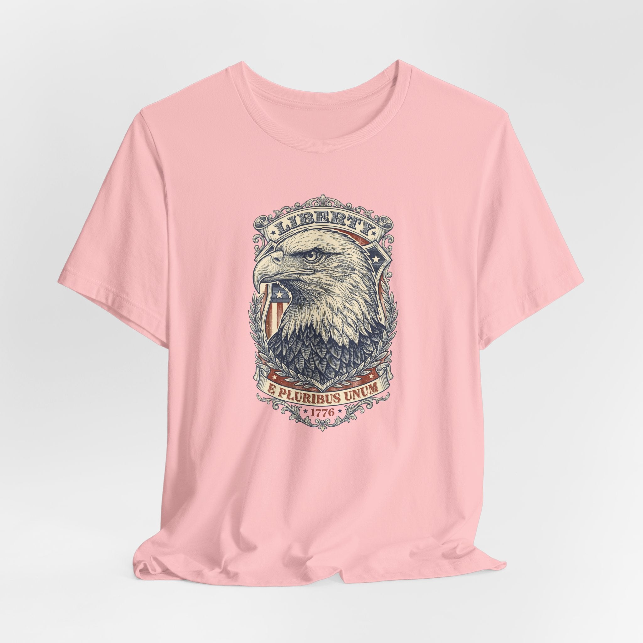 Pink T-shirt with centered liberty eagle head graphic in an oval badge