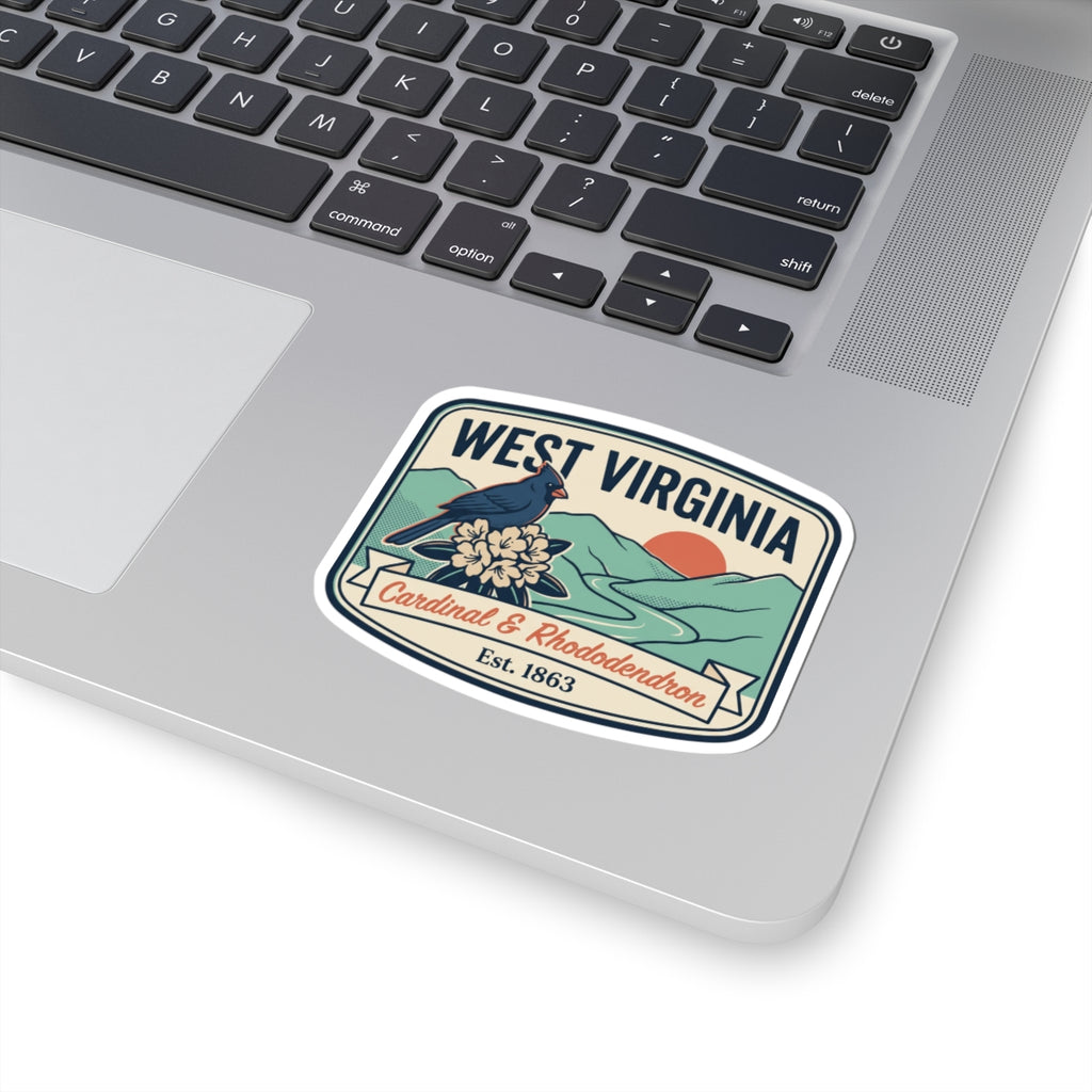 West Virginia state badge sticker on laptop, cardinal and rhododendron, Est. 1863.
