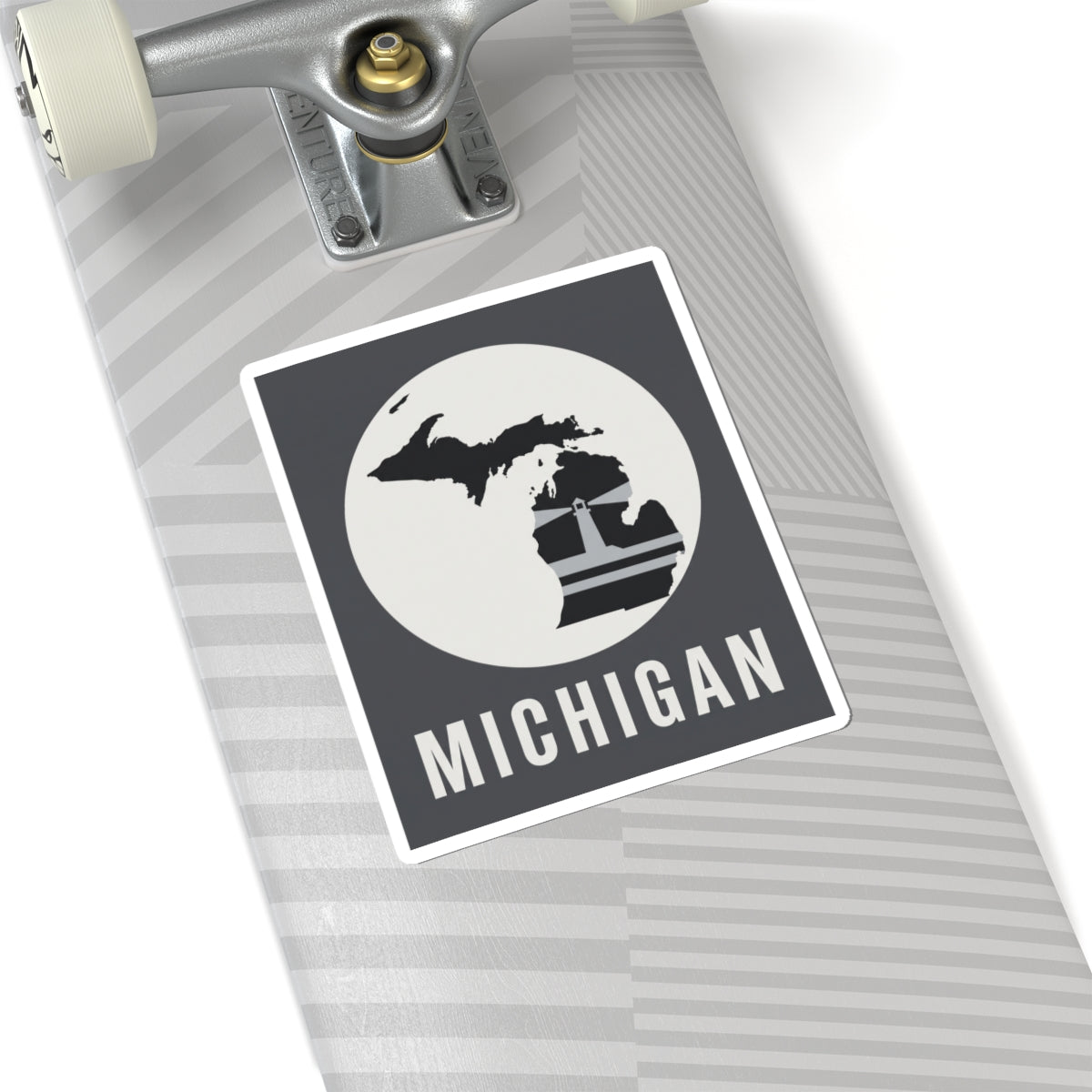 Michigan silhouette decal on notebook cover, black square with white circle and “MICHIGAN”.