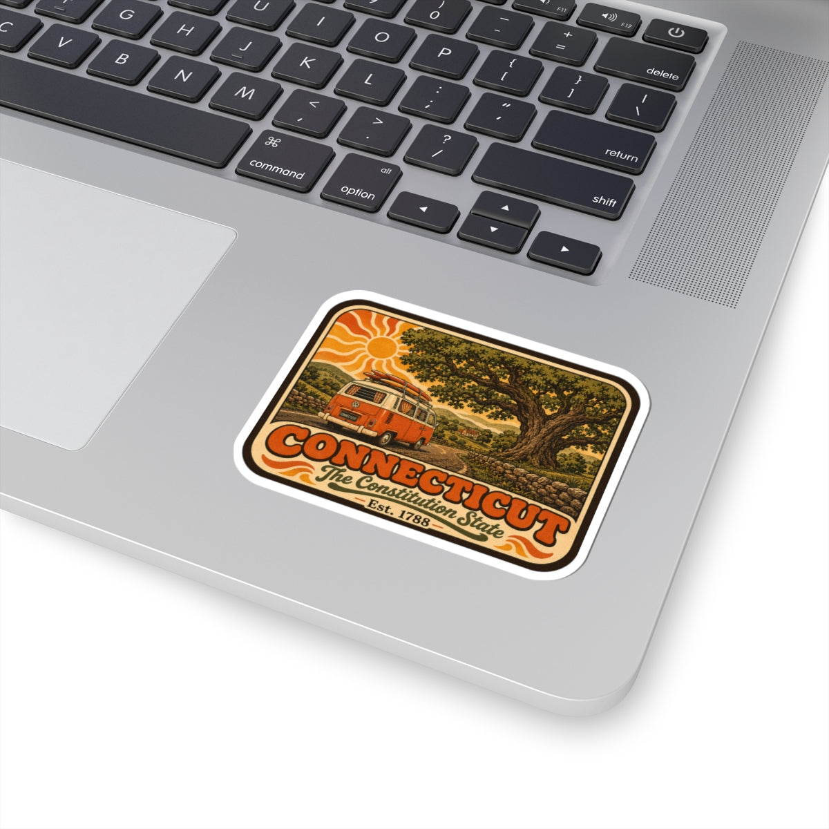 Connecticut vintage camper van sticker on a laptop trackpad and keyboard area.
