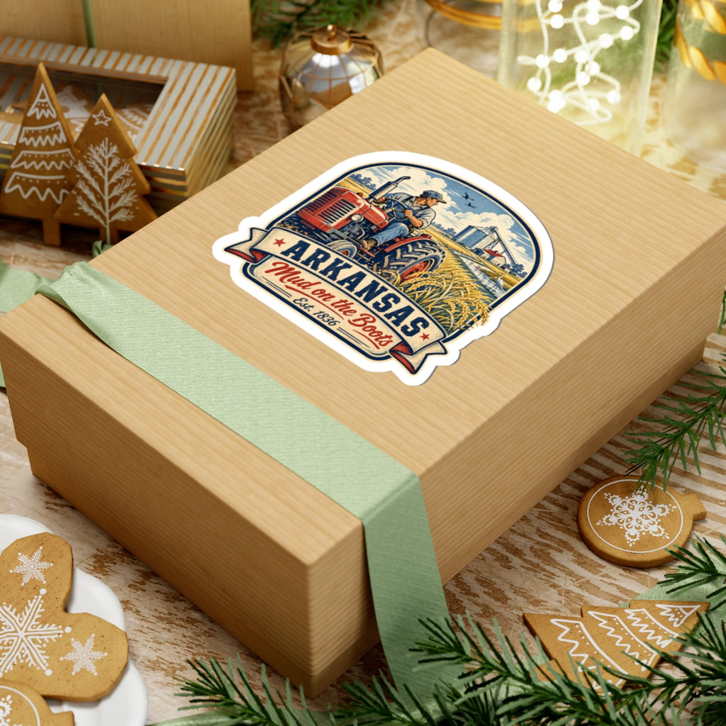 Kiss-cut sticker on gift wrap: Arkansas tractor scene with “Mud on the Boots” text