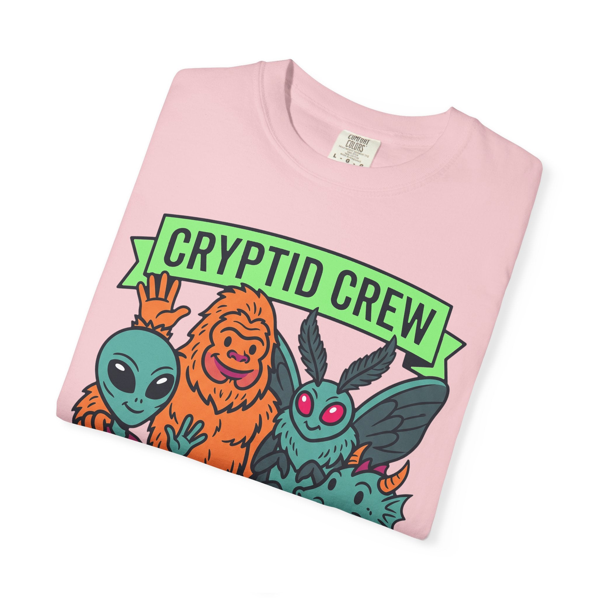 Light pink crew neck t-shirt with folded multicolor cryptid graphic and 'CRYPTID CREW'