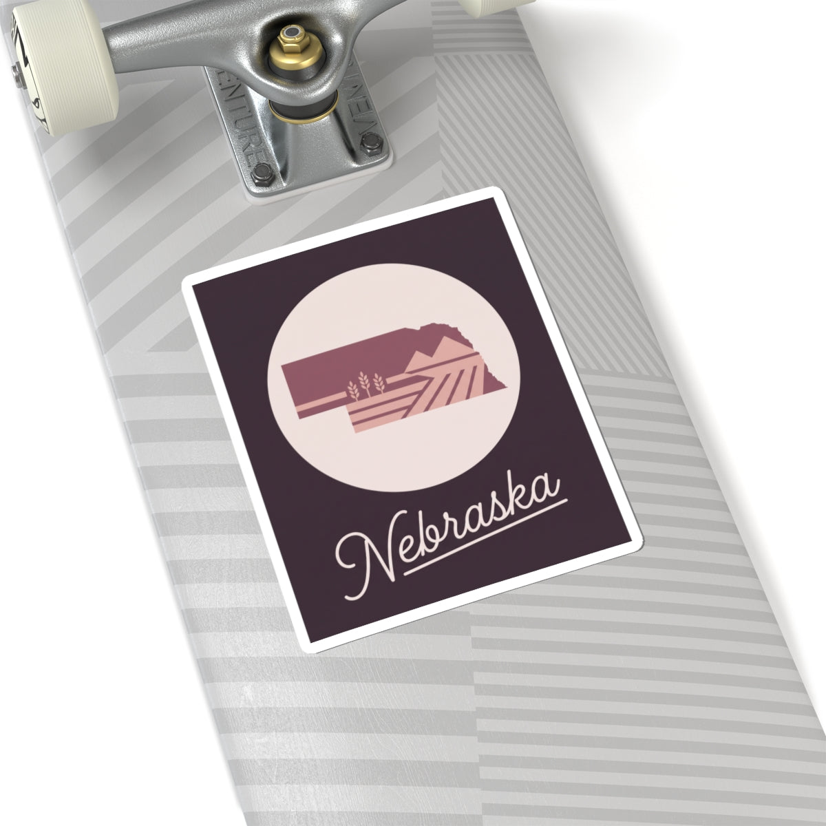 Square Nebraska decal on lined notebook, circular farmland icon with cursive “Nebraska”