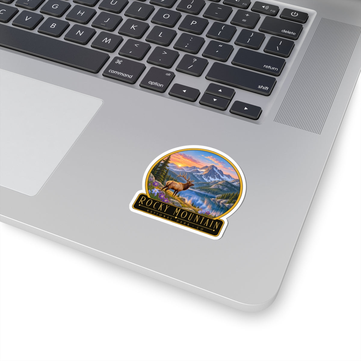 Round landscape sticker with elk, lake, and mountain peaks scene
