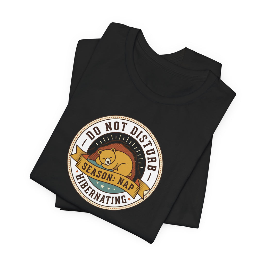 Black T-shirt with round bear sleeping badge graphic on chest