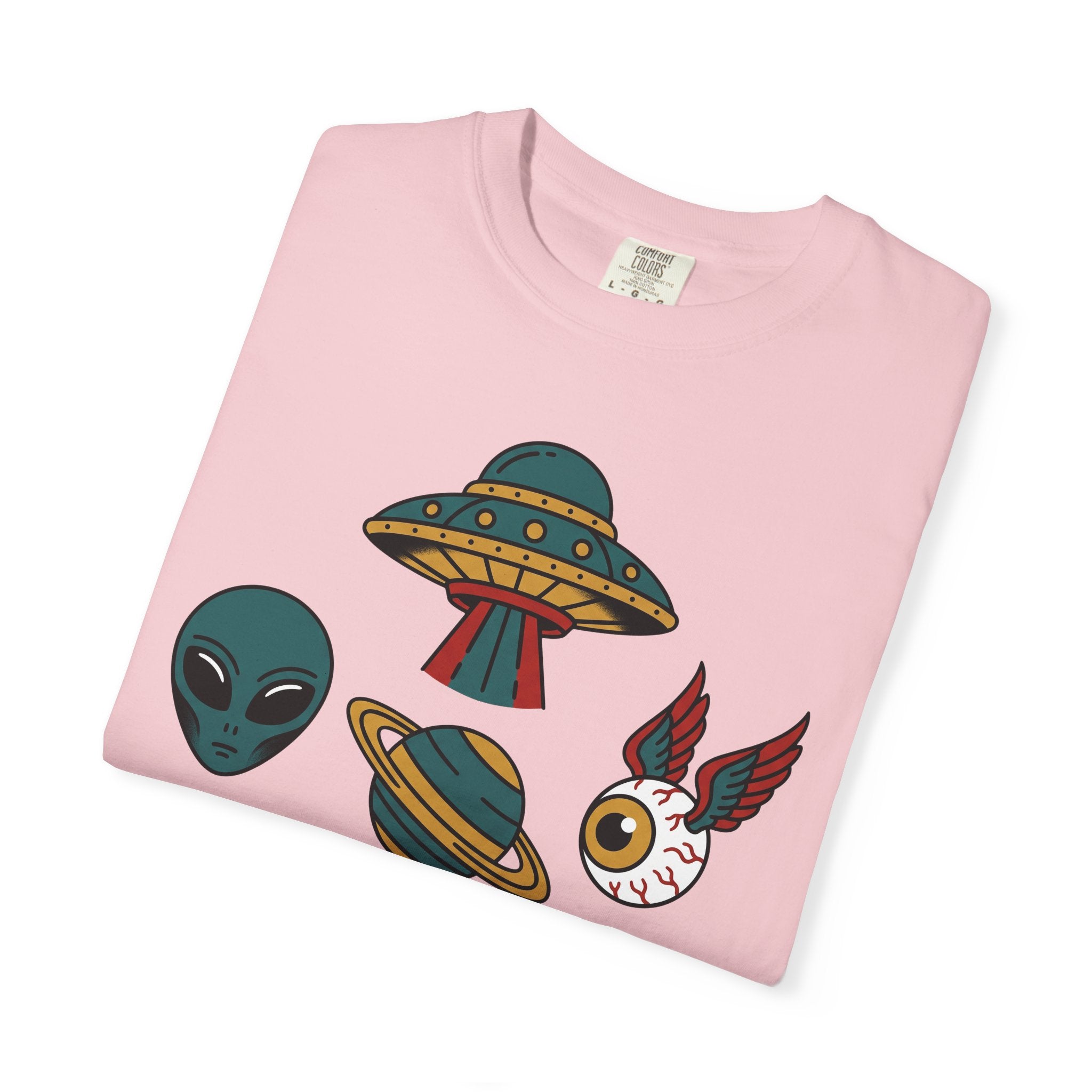 Light pink T-shirt close-up: UFO, alien, and cat graphic
