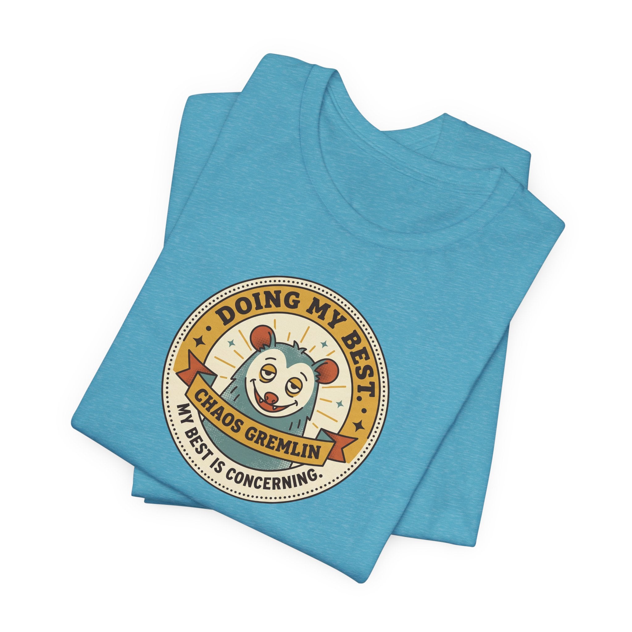 Light blue short-sleeve T-shirt with crew neck and round gremlin badge graphic