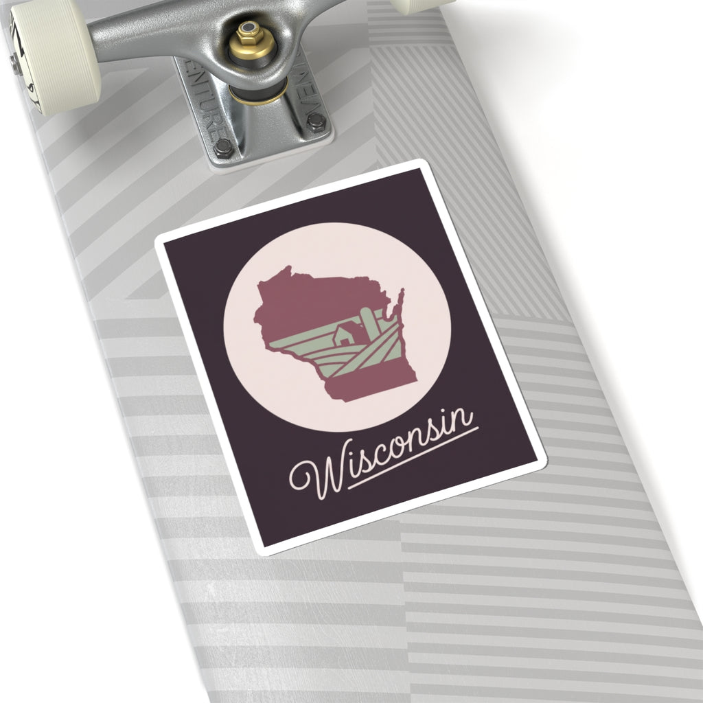 Wisconsin state silhouette decal on a light suitcase: maroon map and “Wisconsin”