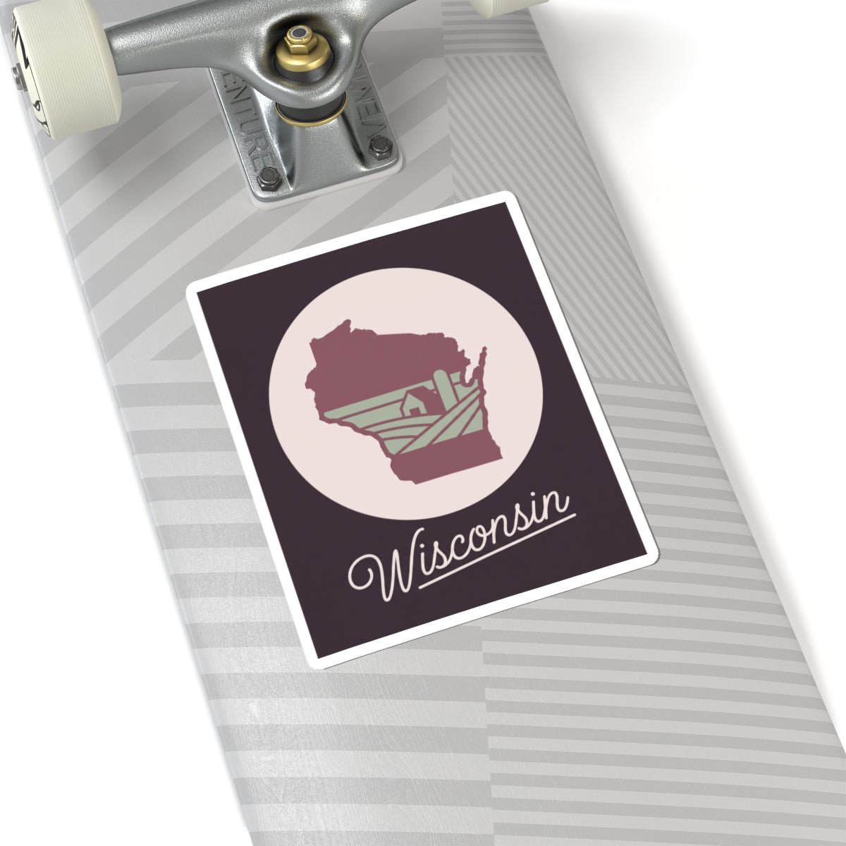Wisconsin state silhouette decal on a light suitcase: maroon map and “Wisconsin”