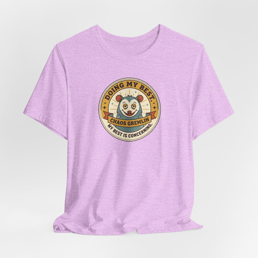 Lavender crew-neck T-shirt with centered circular gremlin badge graphic.