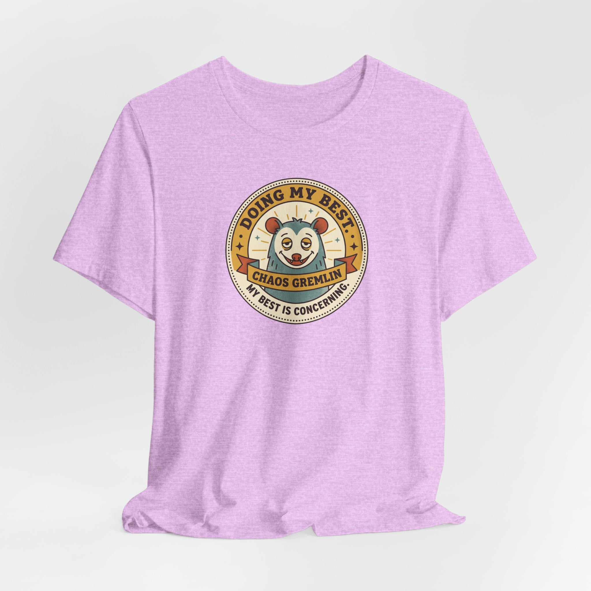 Lavender crew-neck T-shirt with centered circular gremlin badge graphic.
