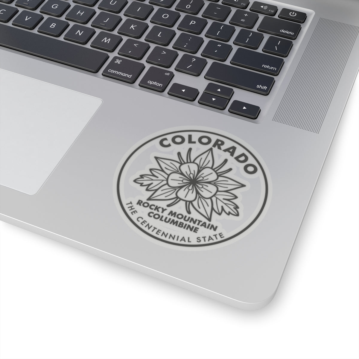 Columbine sticker decal centered on a laptop, circular “COLORADO” and flower graphic
