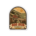 Die-cut Big Sur California fridge magnet with retro orange camper on arched bridge
