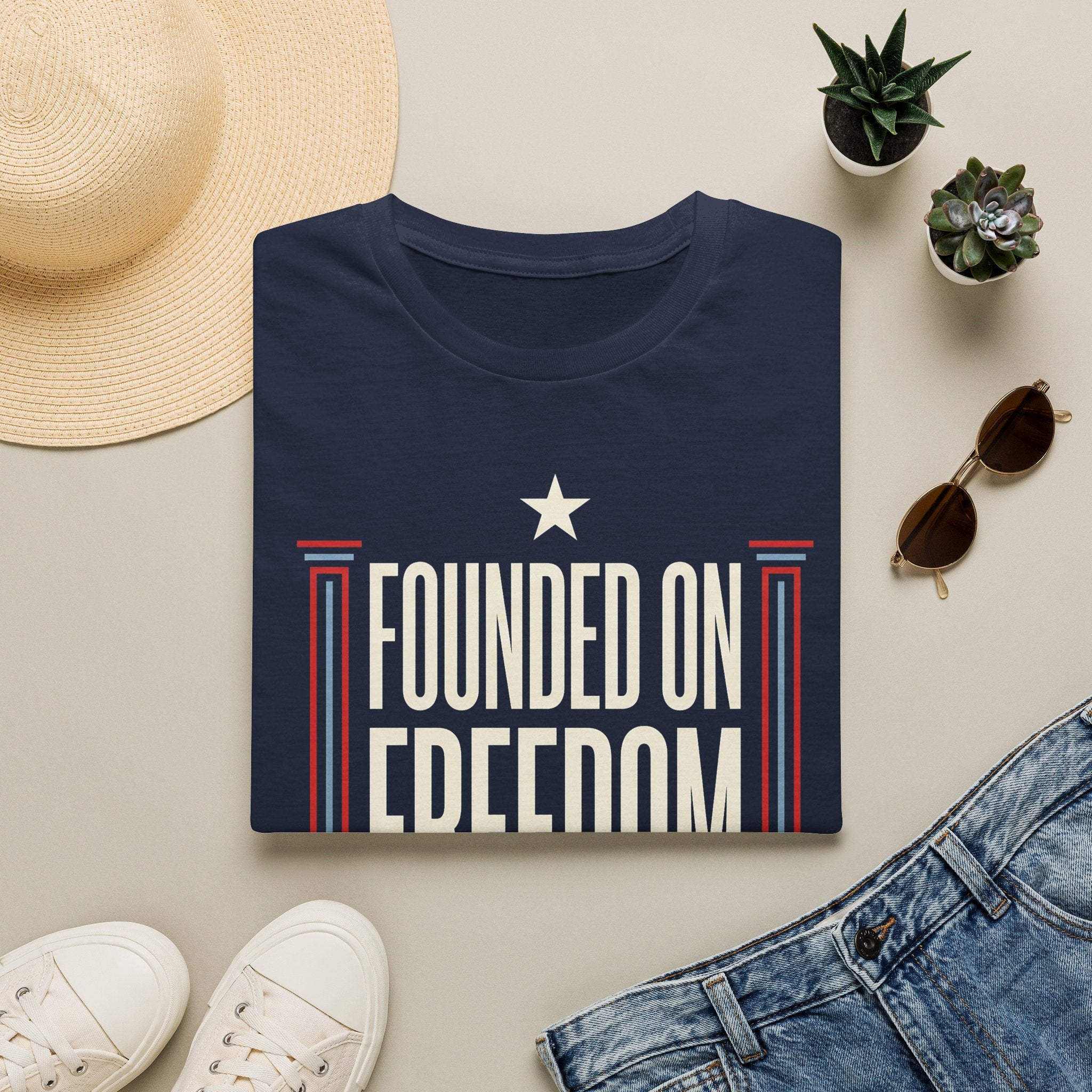 Navy short-sleeve t-shirt with white star and "Founded on Freedom" graphic