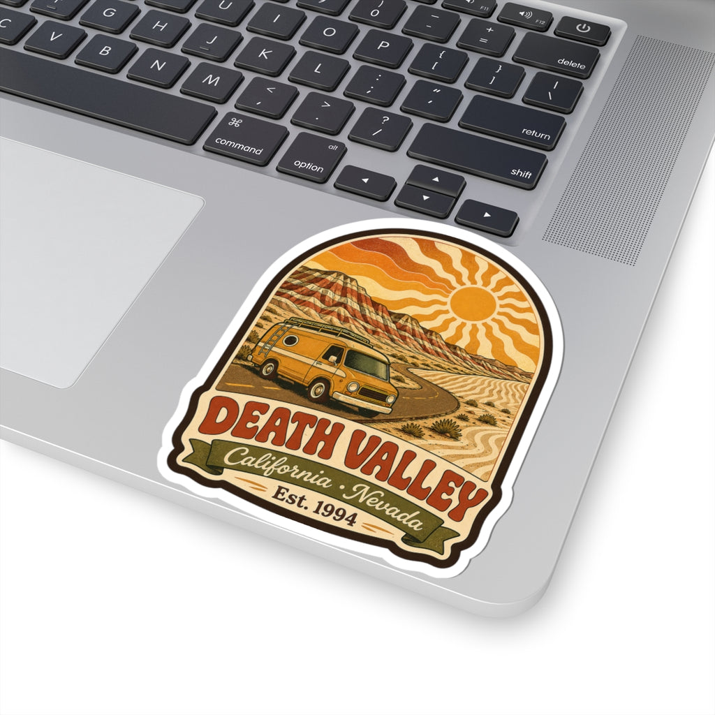 Kiss-cut sticker on laptop featuring desert road, yellow camper van, Death Valley California Nevada