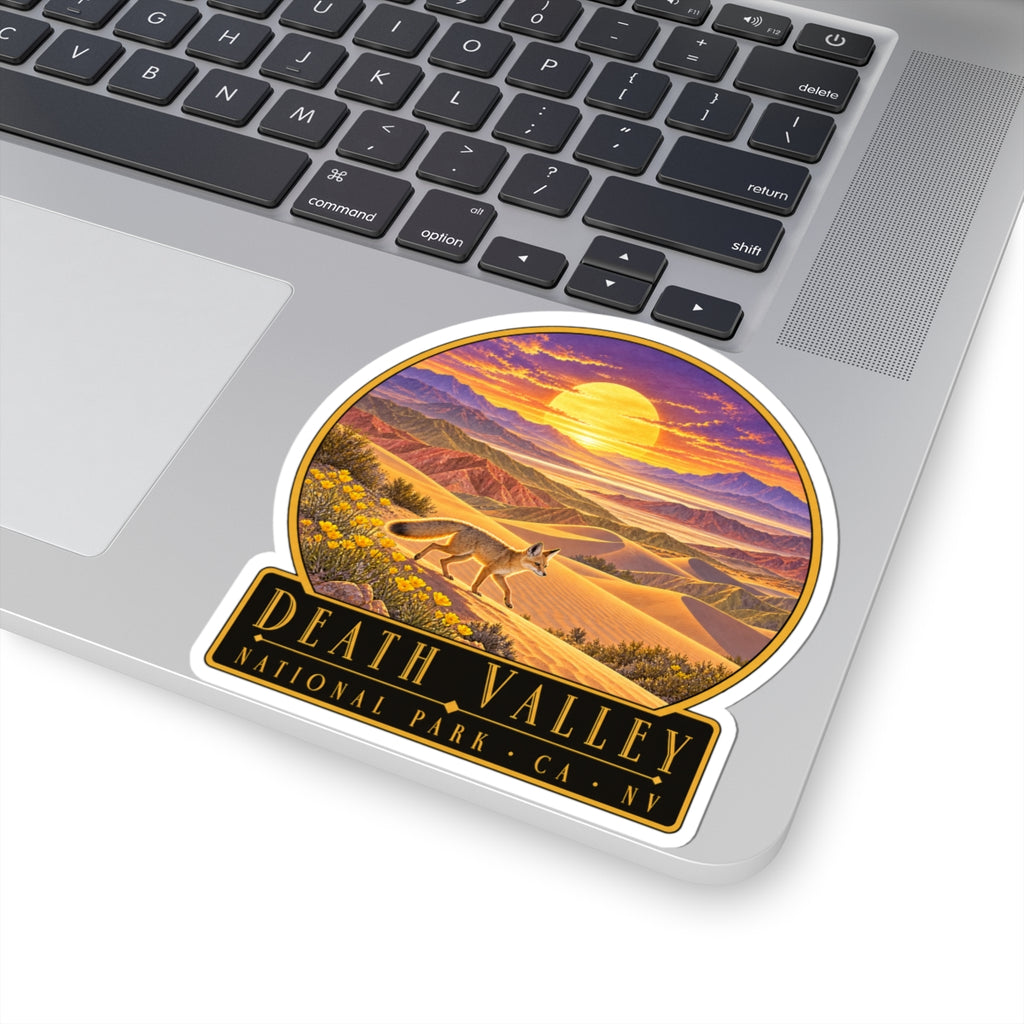 Round sticker featuring desert sunset over mountains, sand dunes, and standing fox