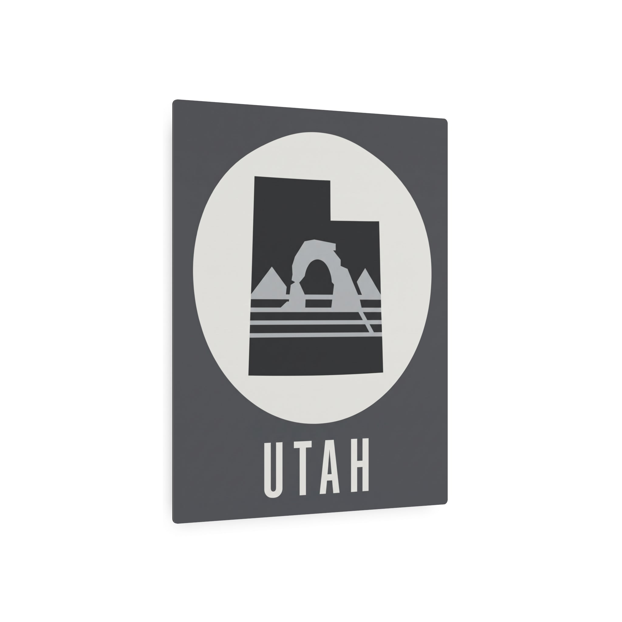 Utah metal wall art sign, dark square with white oval circle, mountain arch graphic and UTAH text