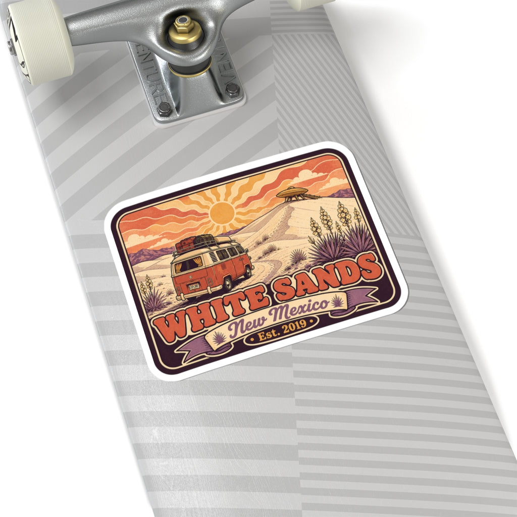 Rounded rectangle sticker on gray notebook; camper, desert sun, White Sands and Est. 2019