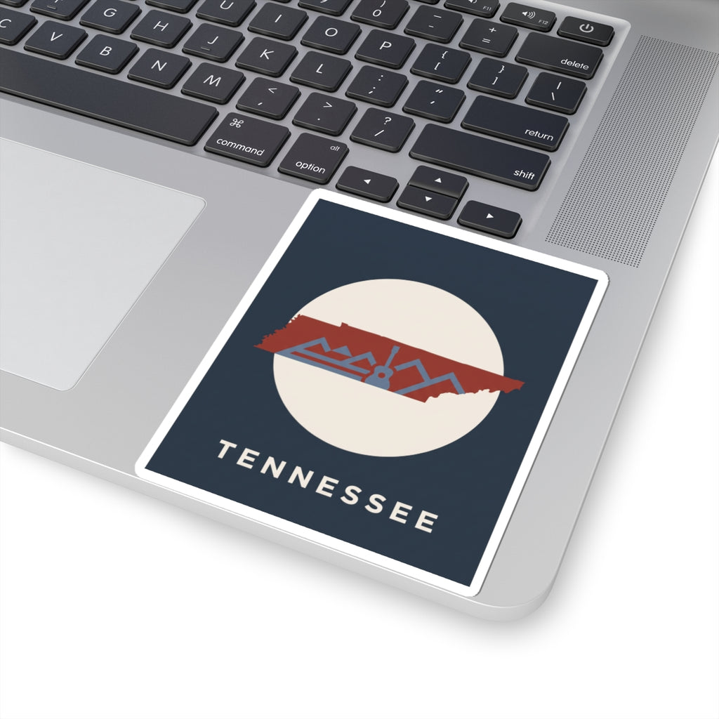 Tennessee outline sticker with mountains and guitar motif on a laptop keyboard