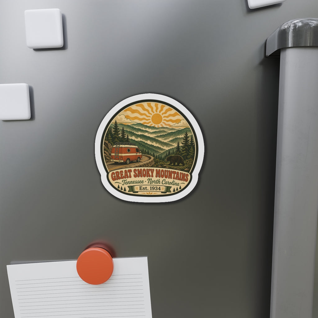 Small round die-cut fridge magnet on stainless door showing Great Smoky Mountains van artwork