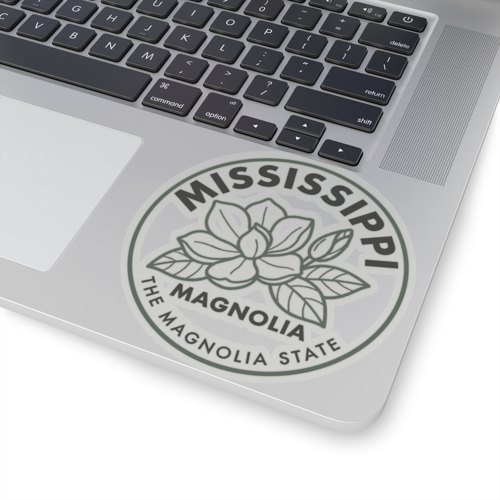 Transparent vinyl sticker on laptop displaying round Mississippi magnolia state seal graphic