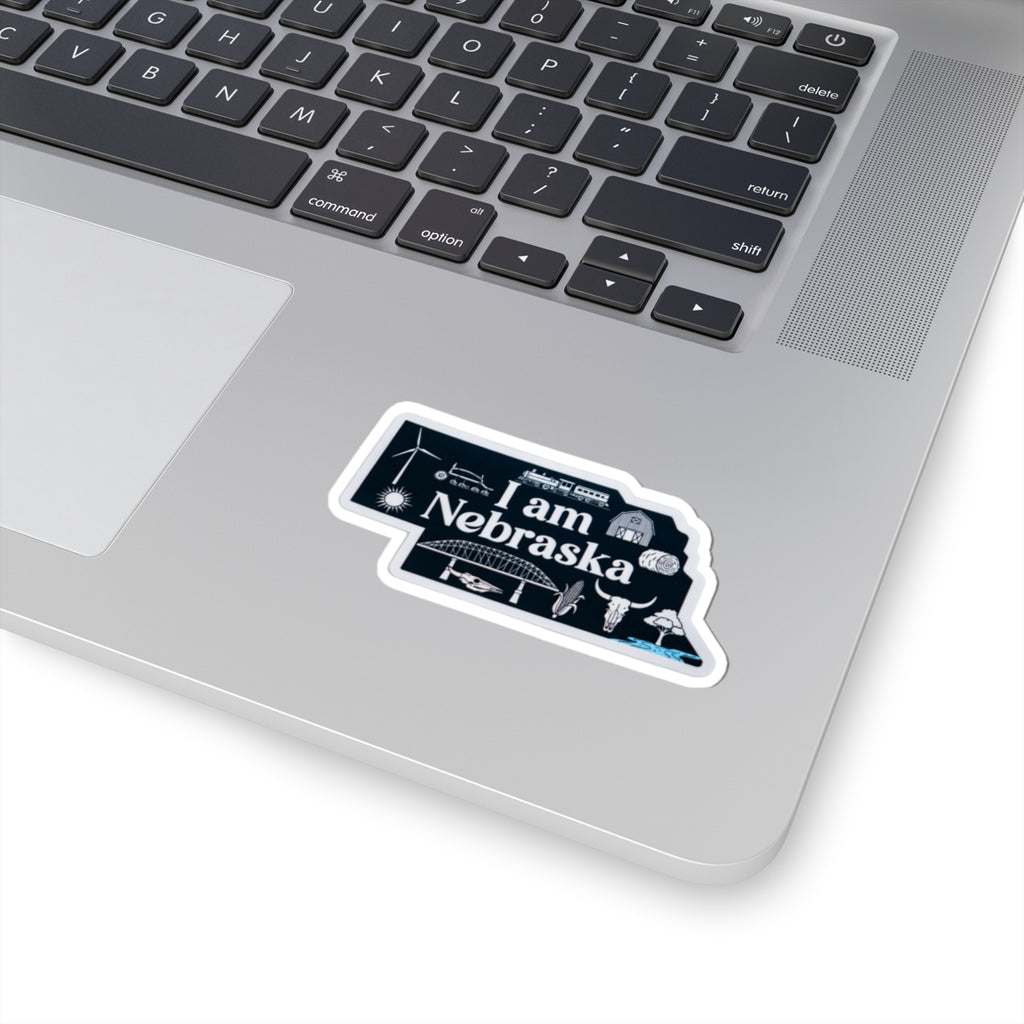 Blue 'I am Nebraska' sticker with white edge, angled on a device surface