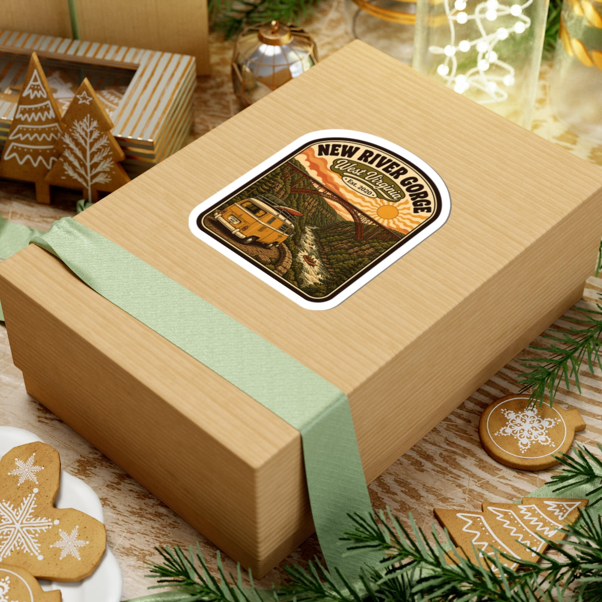 Rounded kiss-cut sticker on wrapped gift box, New River Gorge emblem and camper