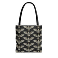 Tote bag with black fabric and repeating gold winged scarab pattern, black handles