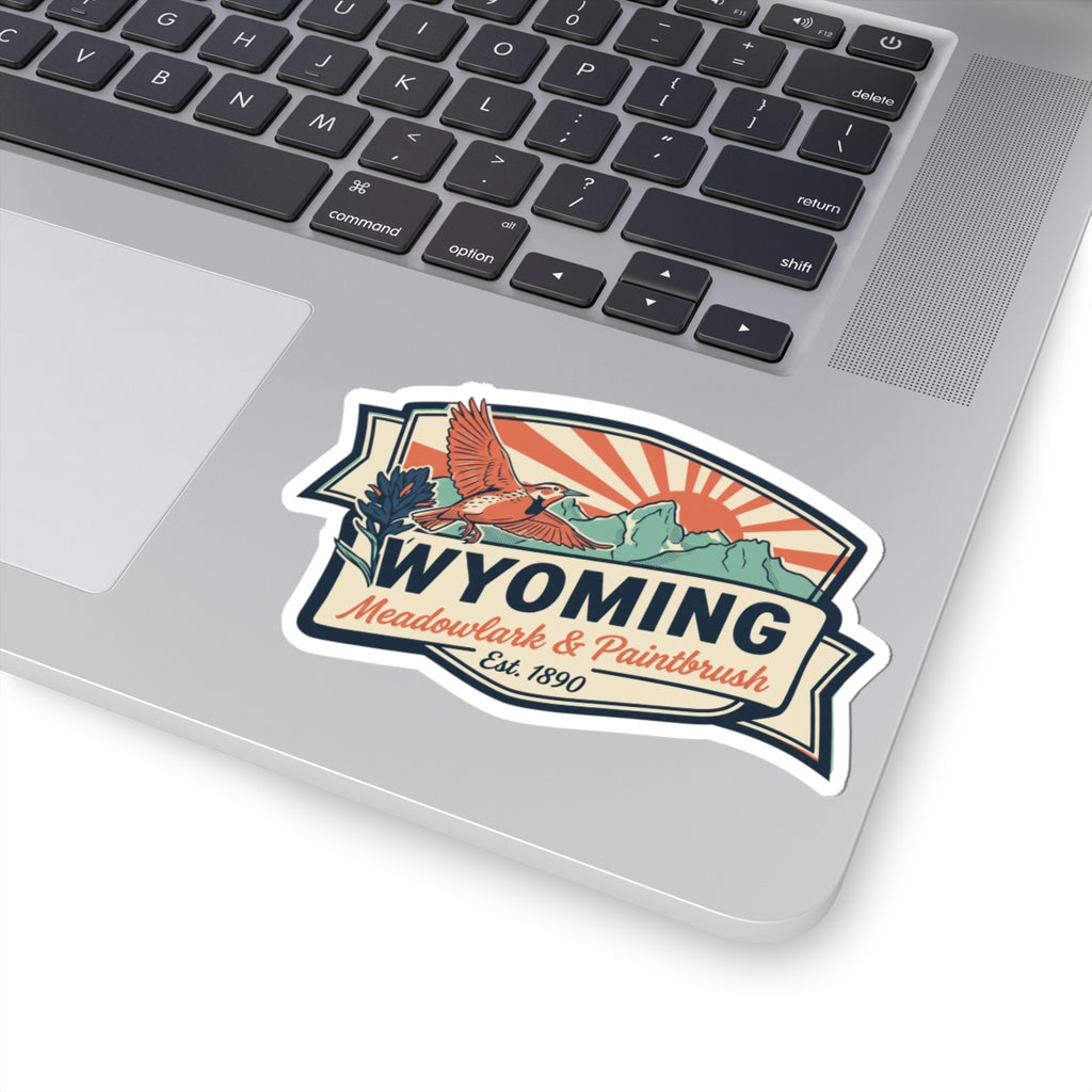 Wyoming emblem sticker with orange meadowlark in flight, paintbrush flowers, and Est. 1890
