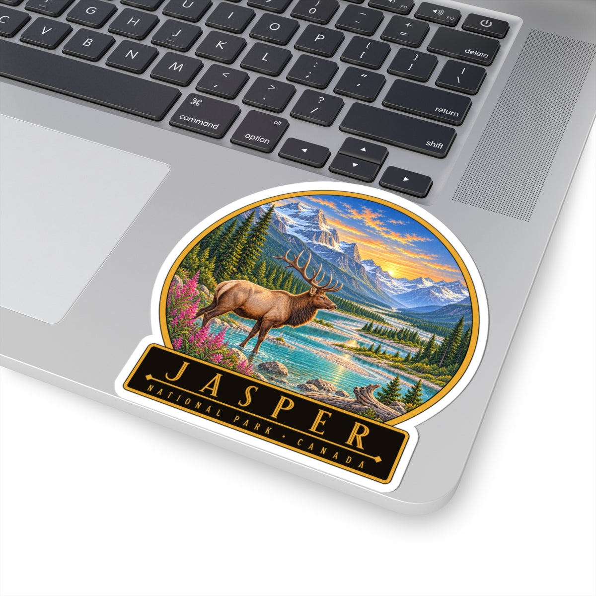 Round vinyl sticker featuring elk, scenic river, pine trees, and Jasper National Park Canada badge