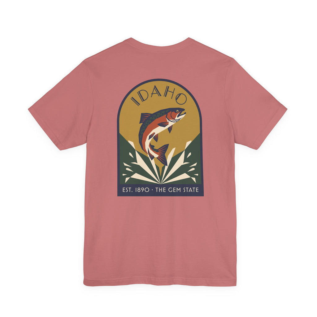 Rose pink crewneck t-shirt with circular Idaho trout badge graphic and "EST. 1890 • THE GEM STATE" text.