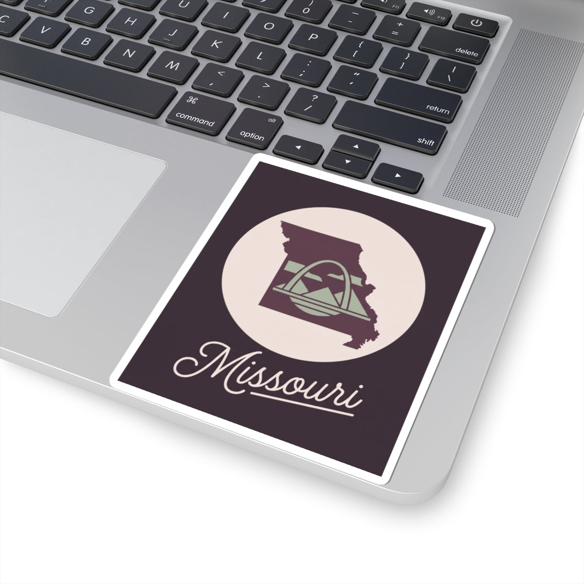 Missouri sticker decal on laptop, dark purple square with emblem circle and Missouri script