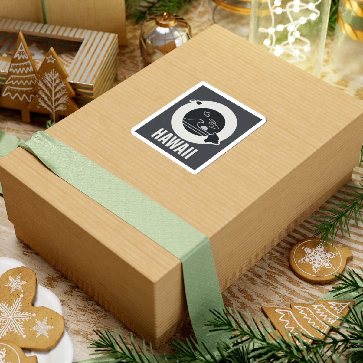 HAWAII square kiss-cut sticker on a wrapped gift box, black wave emblem with island silhouette