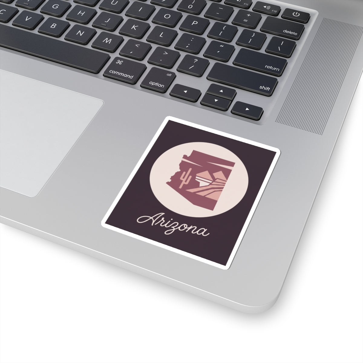 Mauve Arizona state silhouette vinyl sticker on white backing with cursive 'Arizona'