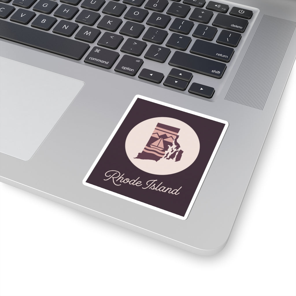 Rhode Island state silhouette decal on laptop surface, circular lighthouse emblem and 'Rhode Island' text