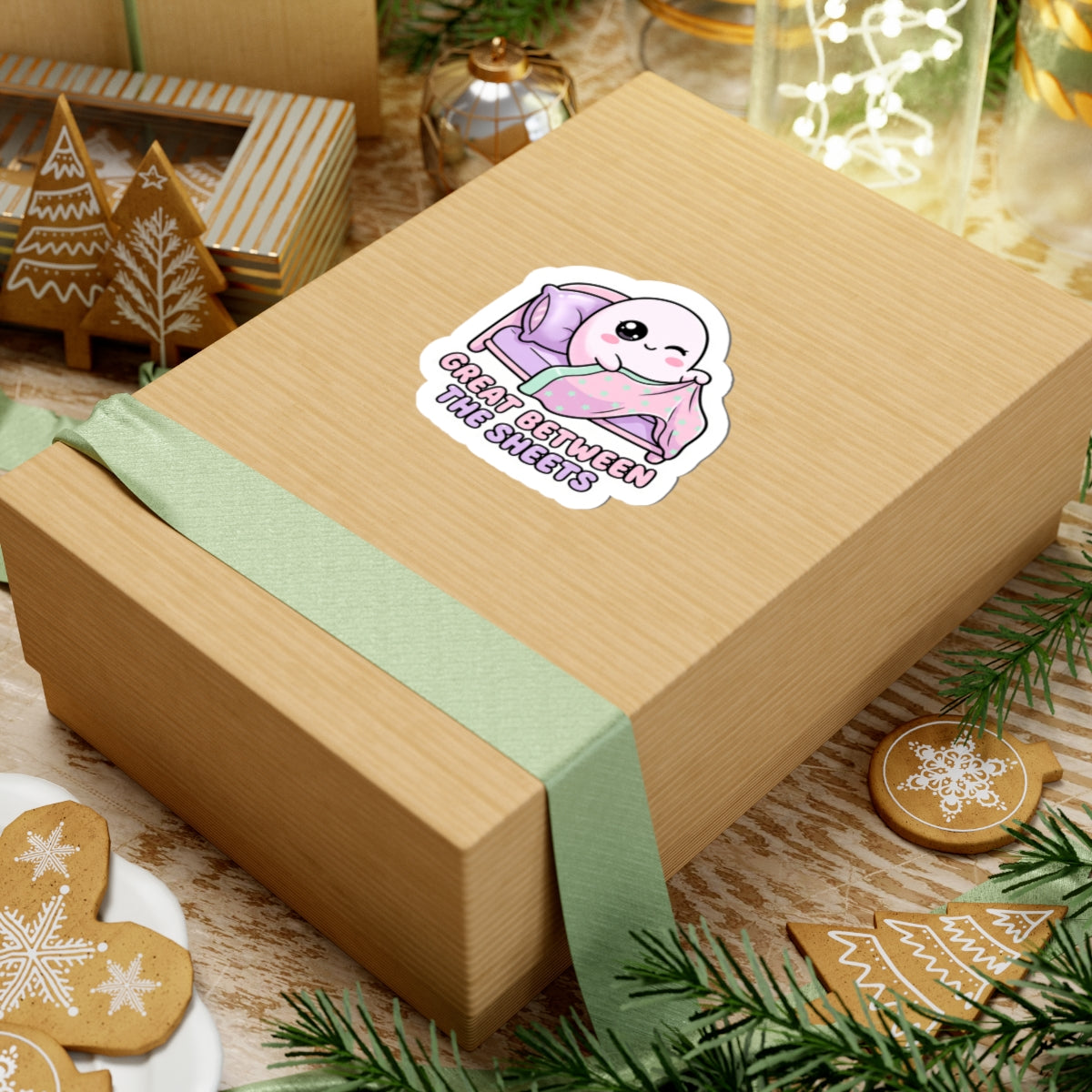 Kiss-cut sticker on gift box: cute ghost lounging in mint star blanket on purple bed