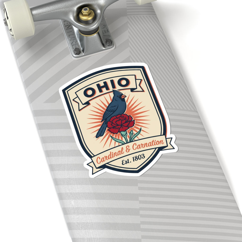 Ohio badge sticker on striped surface: blue cardinal and red carnation, Est. 1803