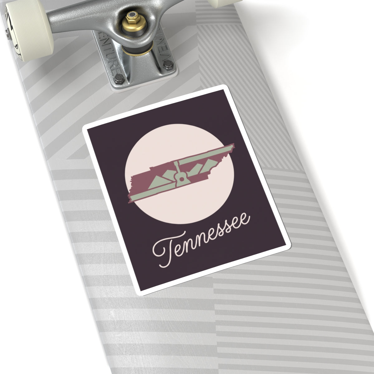 Tennessee state silhouette sticker on striped laptop trackpad area