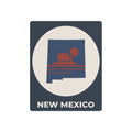 New Mexico metal silhouette wall sign with white oval, red sun graphic, and “NEW MEXICO” text