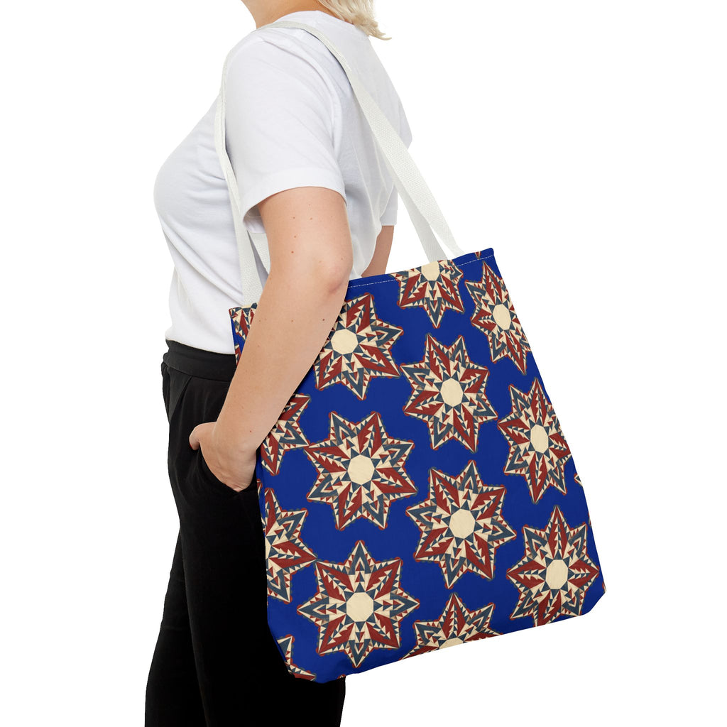 Blue tote bag in starburst floral pattern with light fabric handles