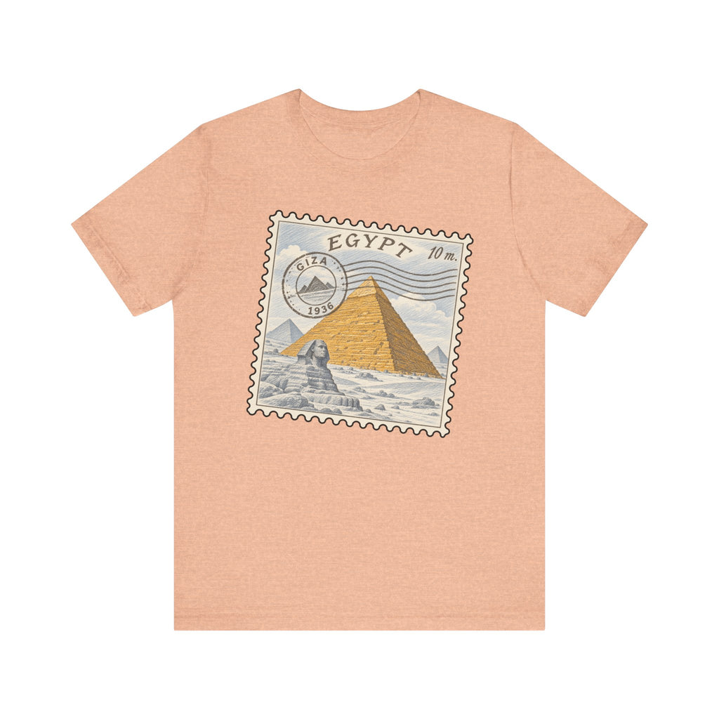 Peach heather T-shirt with Egypt stamp graphic featuring pyramids on front.