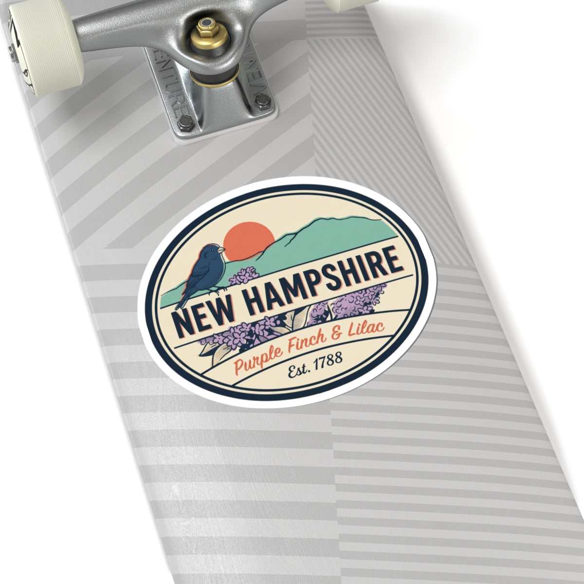 Round New Hampshire sticker on a notebook cover with purple finch and lilac artwork